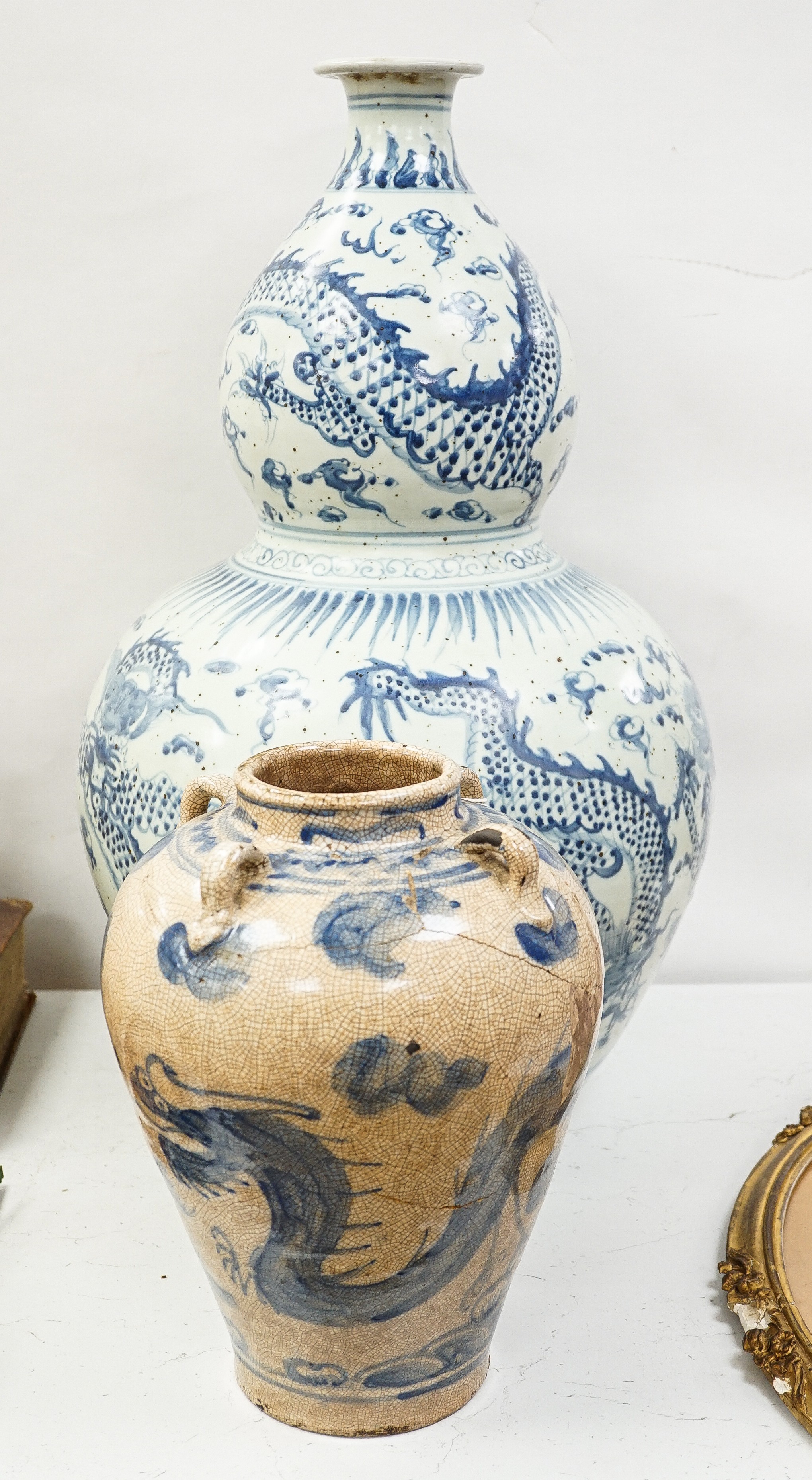A large Chinese blue and white 'dragon' double gourd vase, 64cm high and an Annamesse style blue and white crackle glaze jar